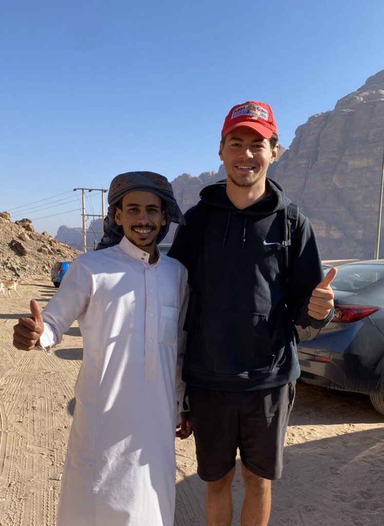 Sam King with Hussein Hamd in Wadi Rum after Samuel built his website